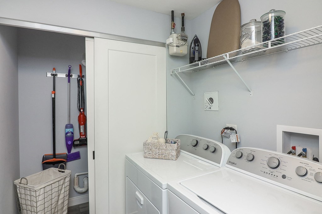 a washer and dryer in a laundry room with a closet