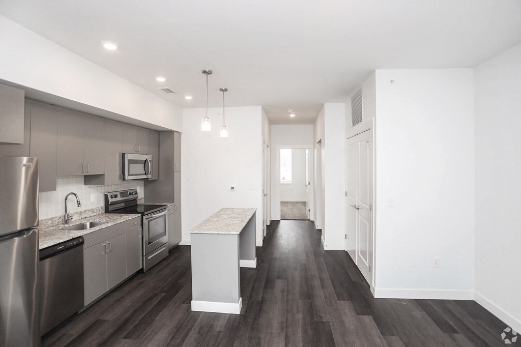 view of a kitchen with island and stainless steel appliances