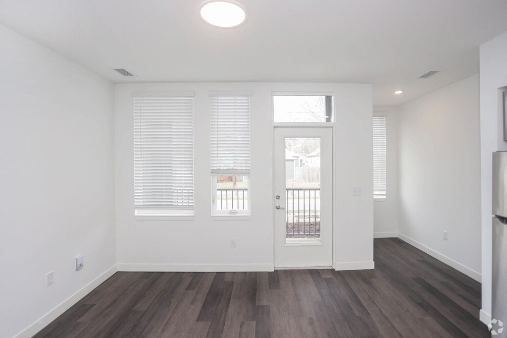 a apartment living room with large windows and door
