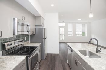 a kitchen with stainless steel appliances and island