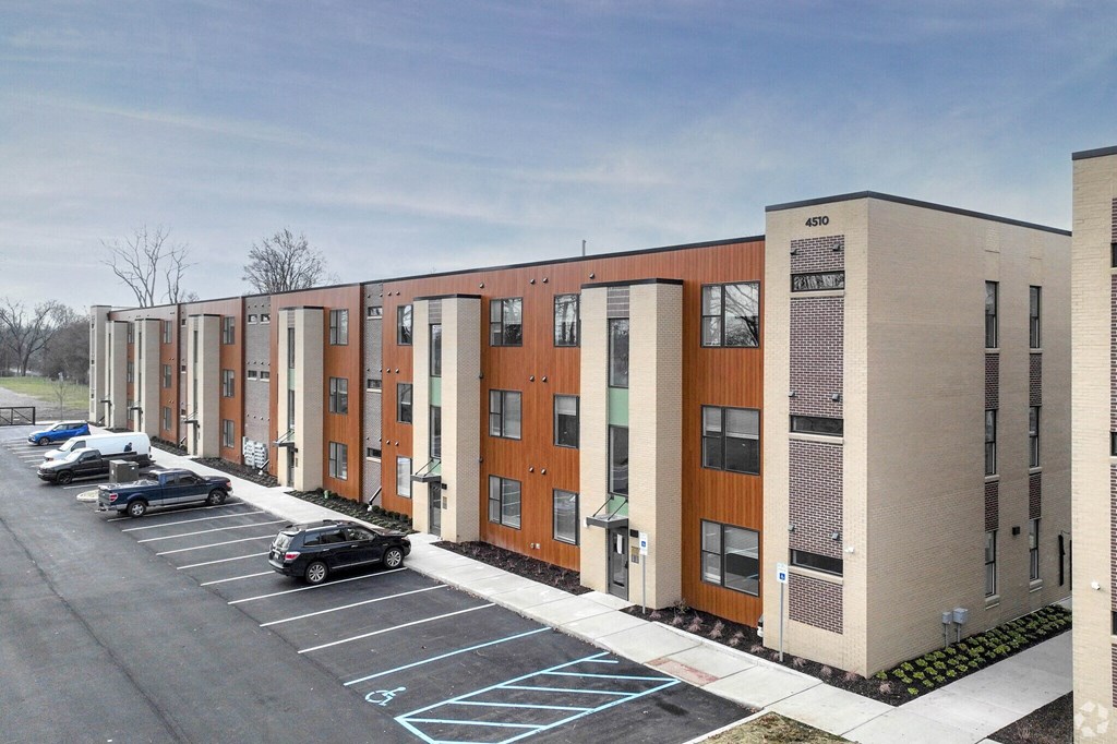 an exterior view of a building with a parking lot