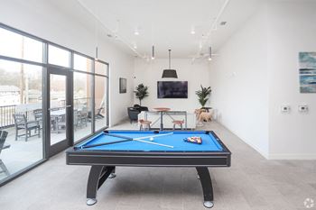 a games room with a pool table and a tv