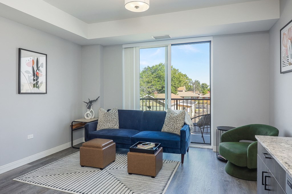 a living room with a blue couch and a green chair