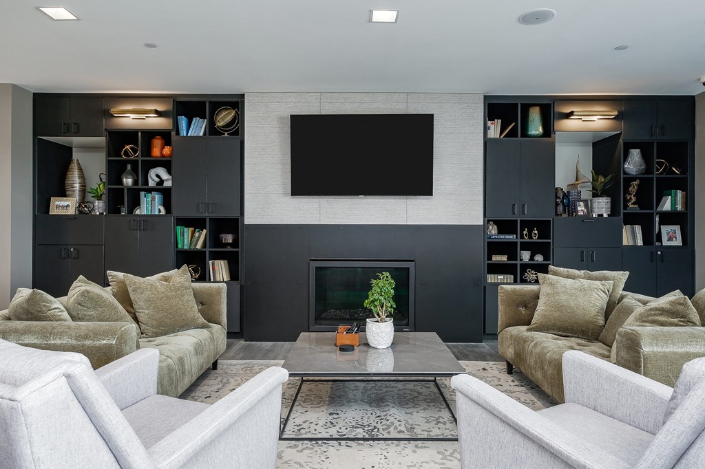 a living room with couches and a coffee table and a television