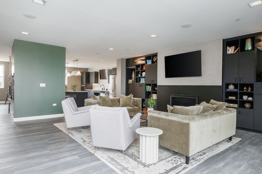 a living room with a couch and chairs and a television