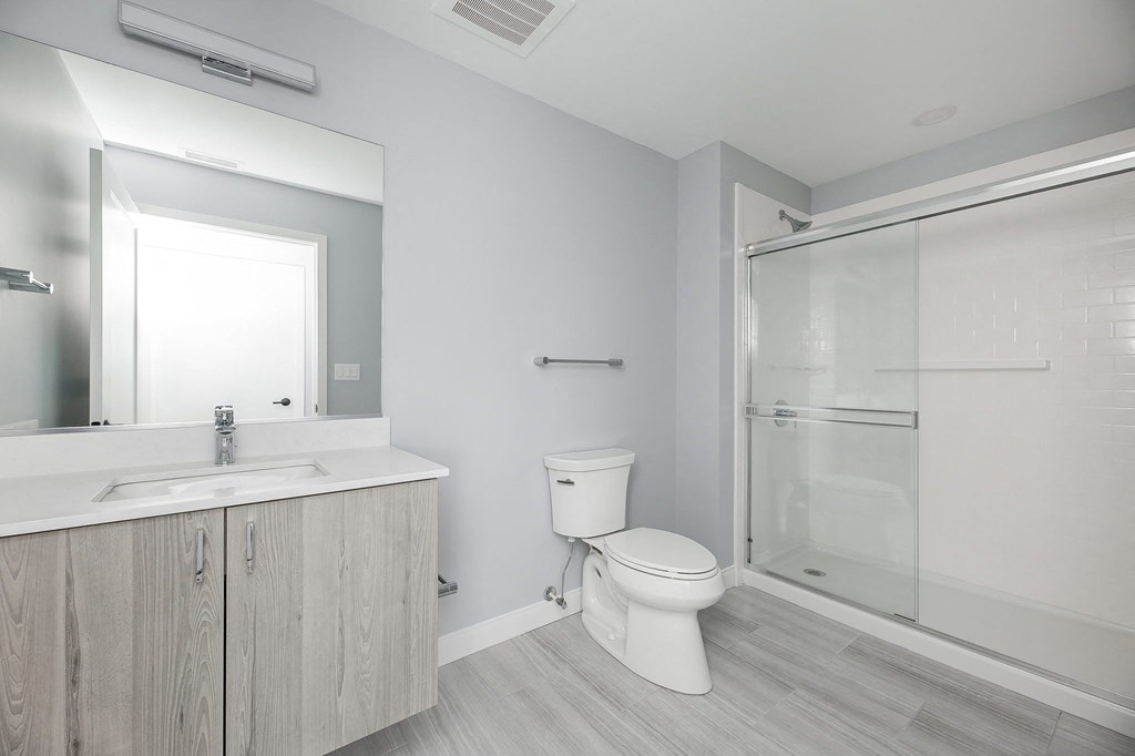 a bathroom with a toilet and a sink and a shower