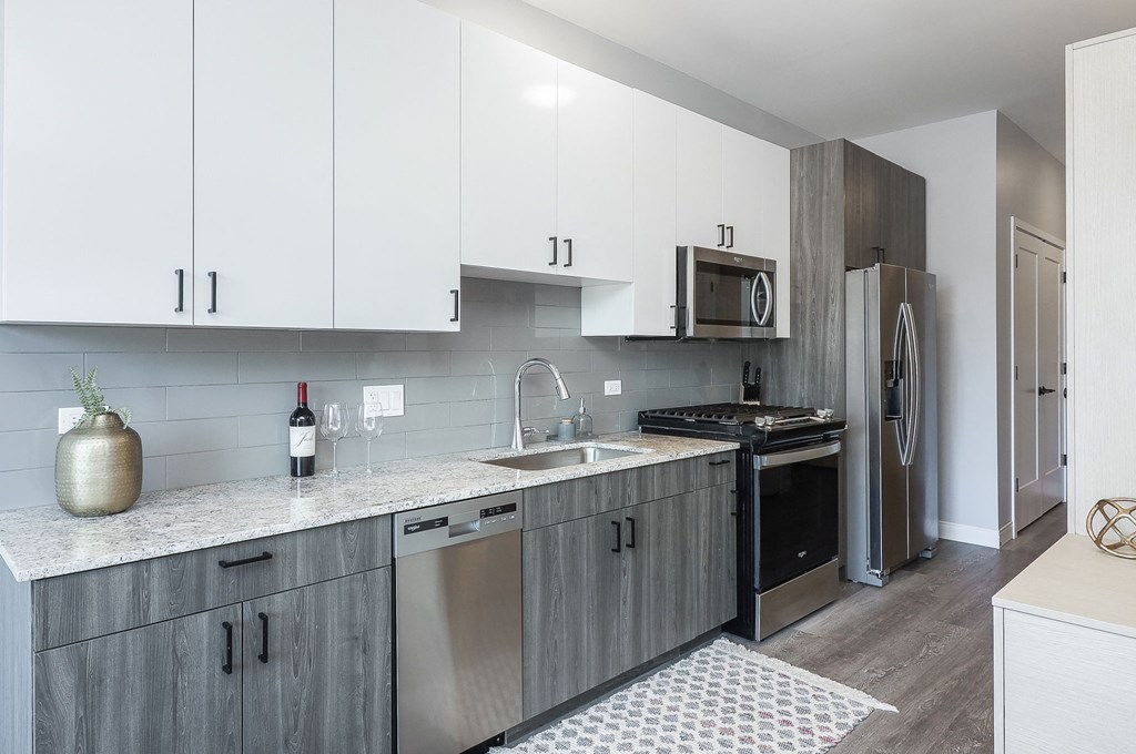 A kitchen with a stove top oven and a microwave above it.