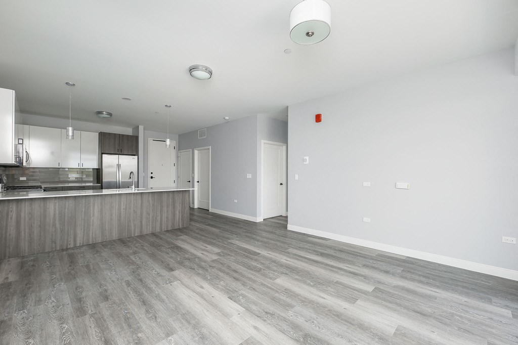 an empty living room and kitchen in a new home