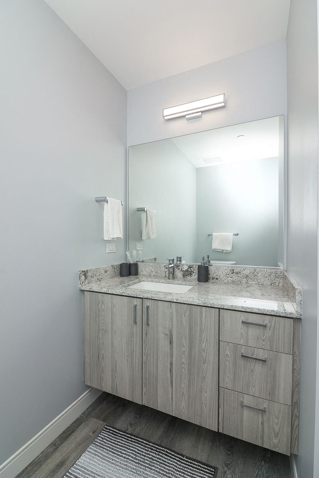 A bathroom with a vanity and a mirror.