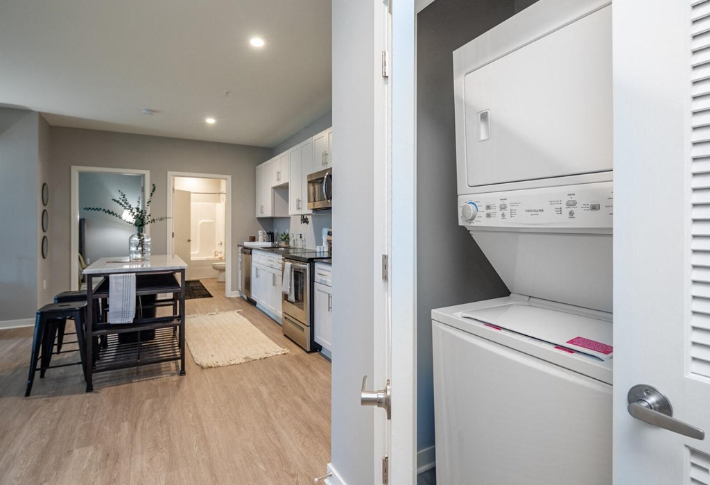 a kitchen and dining room with a refrigerator and a table