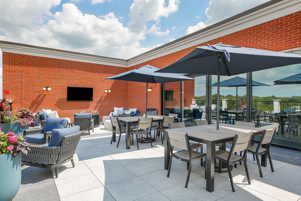 an outdoor patio with tables and chairs and umbrellas