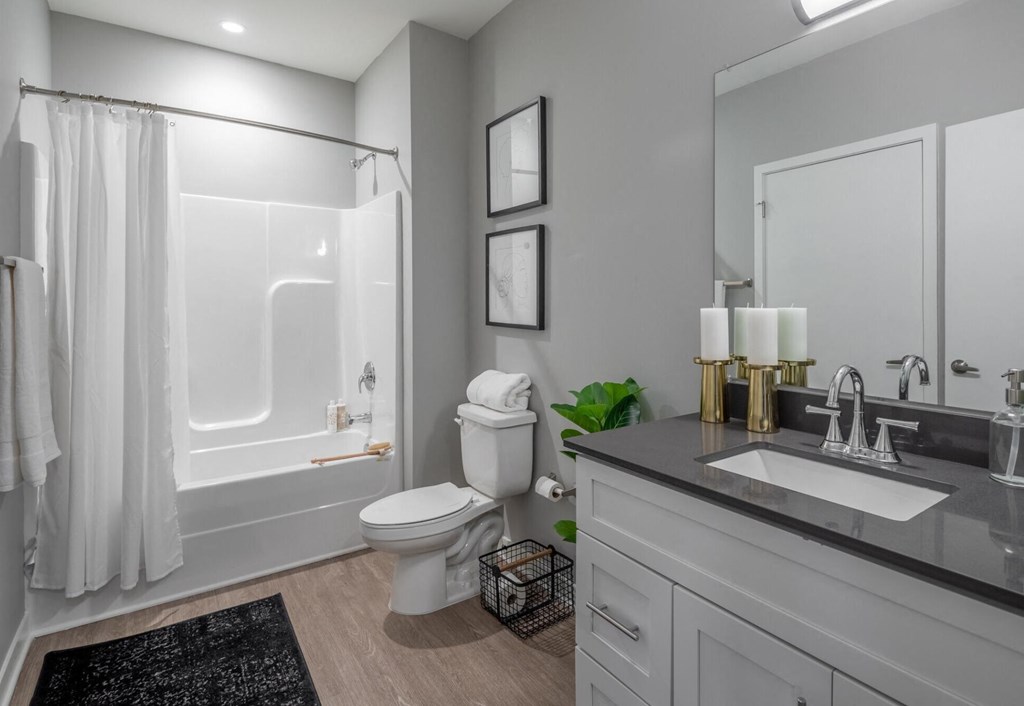 a bathroom with a shower and a sink and a toilet