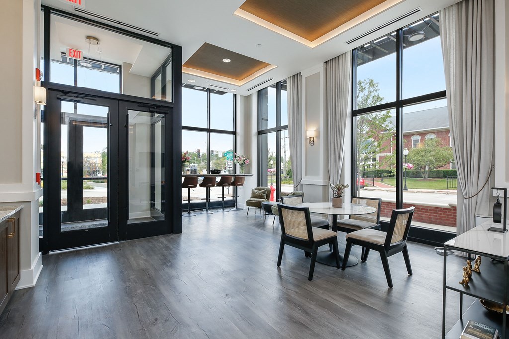 a dining room with glass doors and a table and chairs