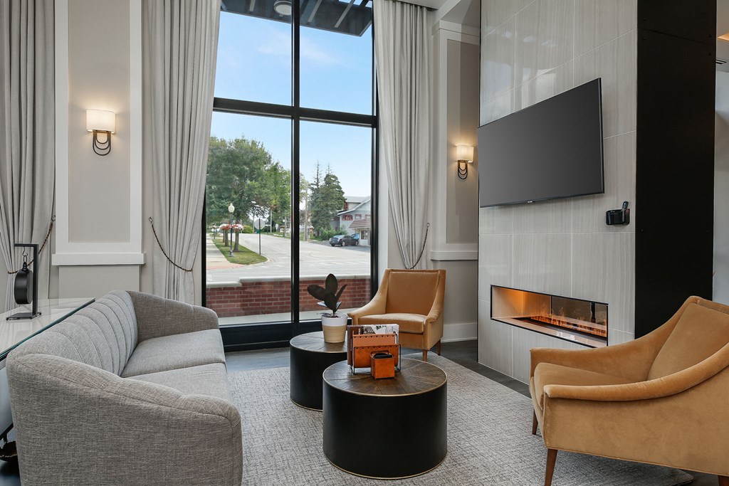 a living room with a couch and chairs and a television