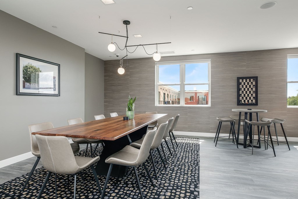 a dining room with a wooden table and chairs