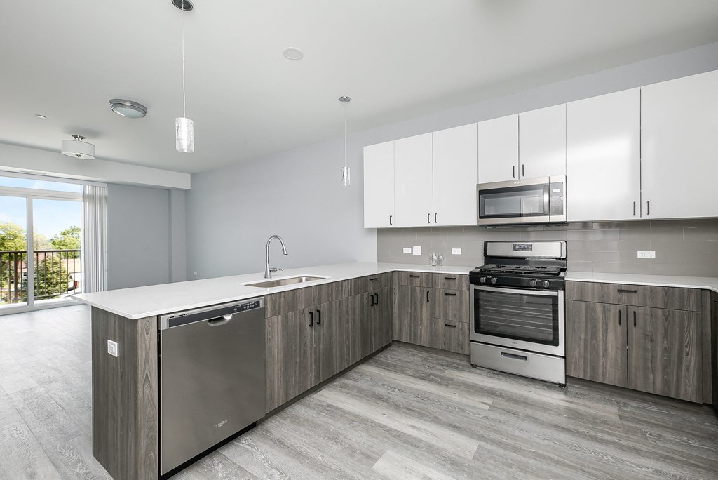 a kitchen with wooden cabinets and stainless steel appliances