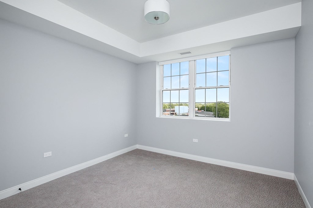 an empty room with white walls and a window
