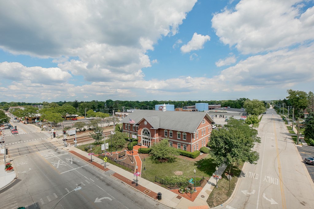 an aerial view of a brick building on the corner of a city street