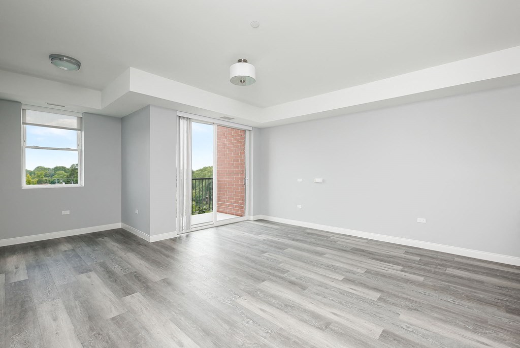 an empty living room with white walls and wood floors