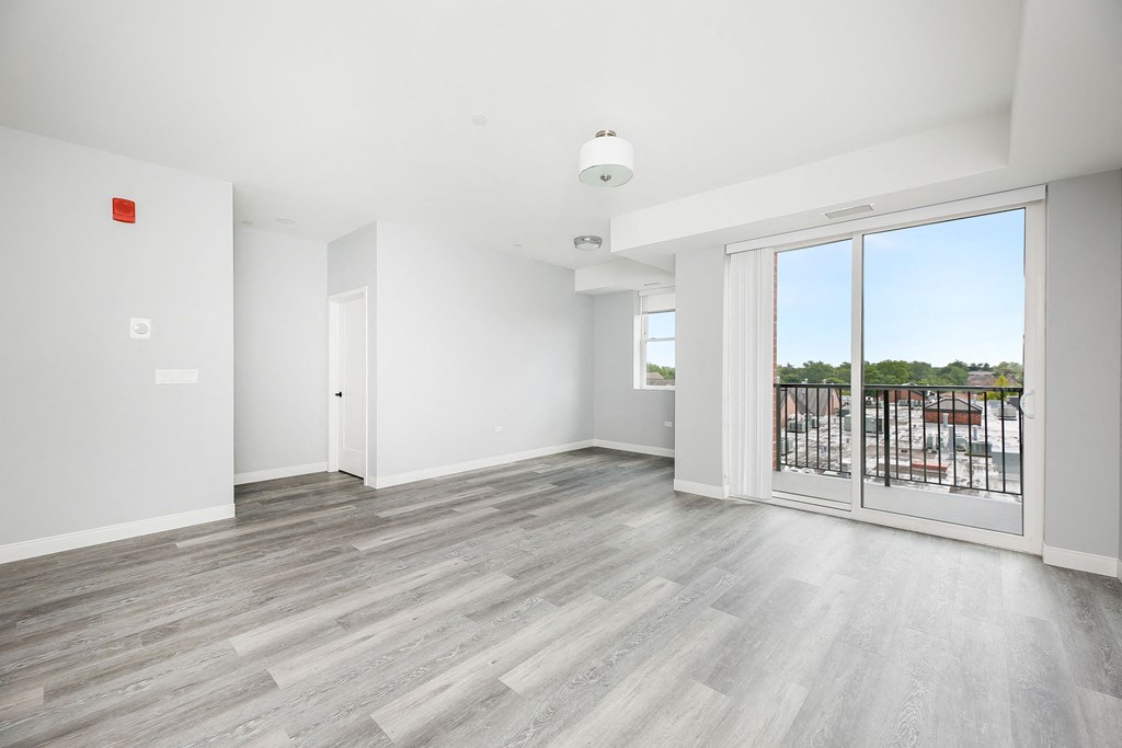 a living room with a glass door and a balcony