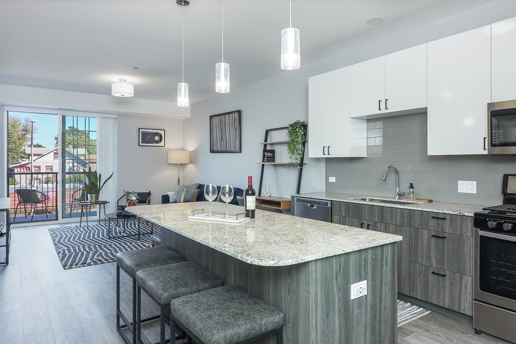 A kitchen with a bar area and a dining table.