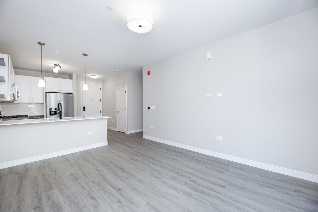 A kitchen area with a counter and cabinets.
