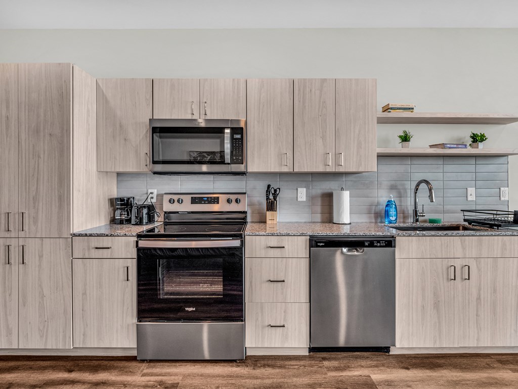 a kitchen with stainless steel appliances and wooden cabinets