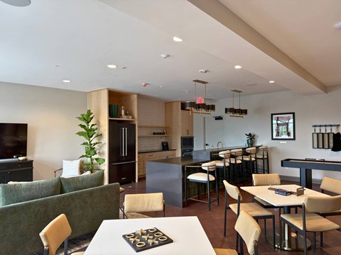 A modern kitchen with a dining table and chairs.