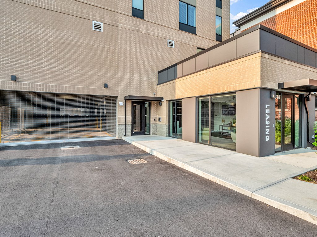 an exterior view of an apartment building with a leasing office sign