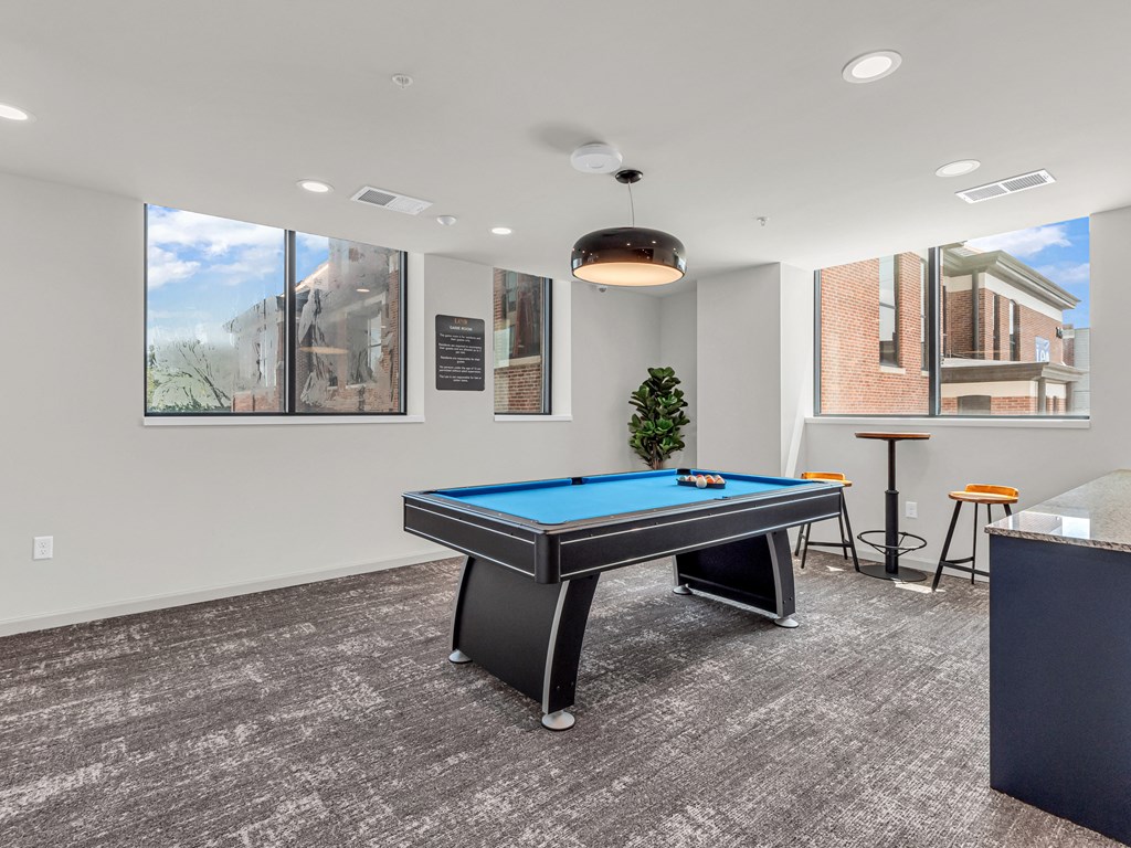 a room with a pool table in the middle