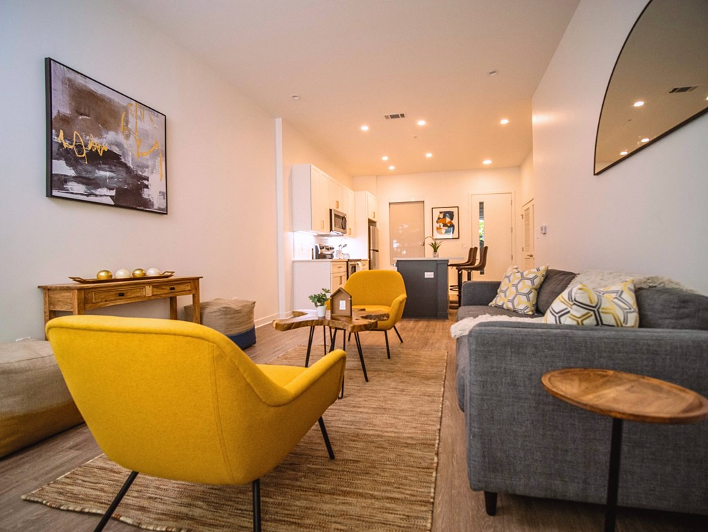 a living room with yellow chairs and a couch