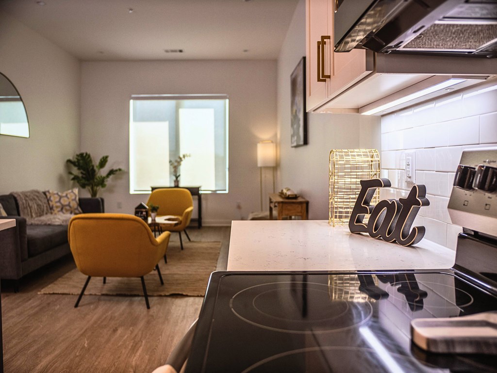 a kitchen and living room with a stove top