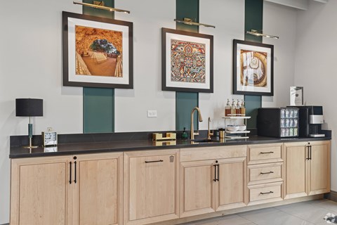 A kitchen with a black counter top and wooden cabinets.