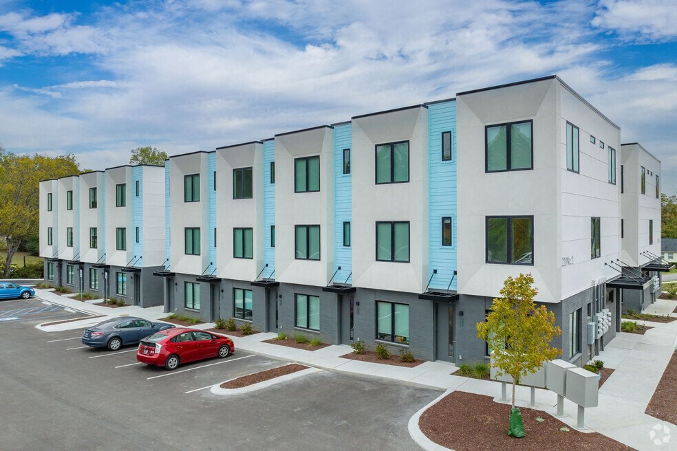 a view of a building with cars parked in front of it