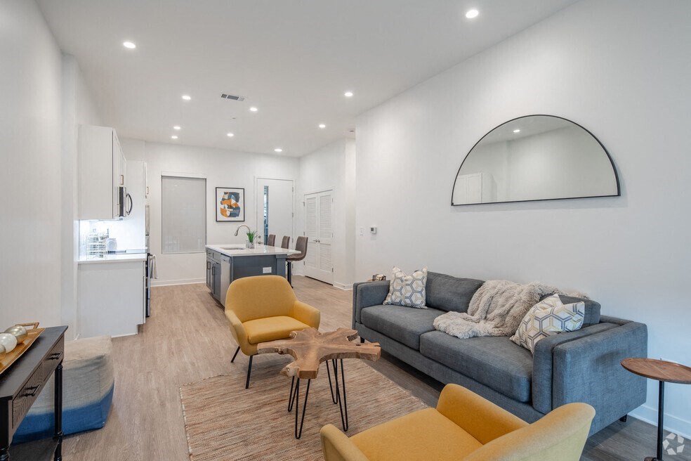 a living room with a couch and a dining room