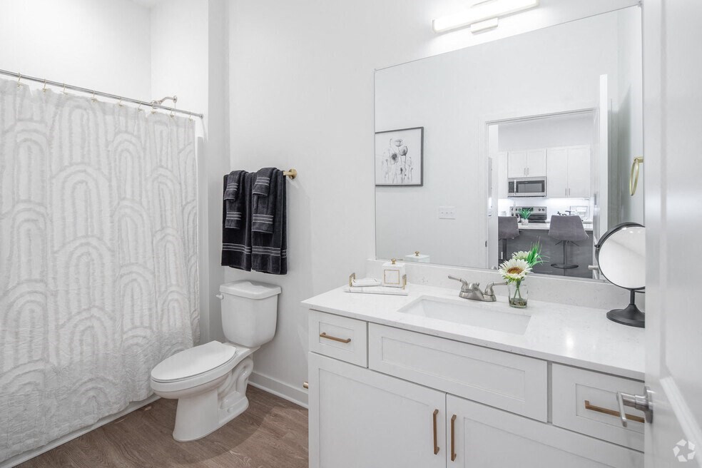 a white bathroom with a shower and a sink