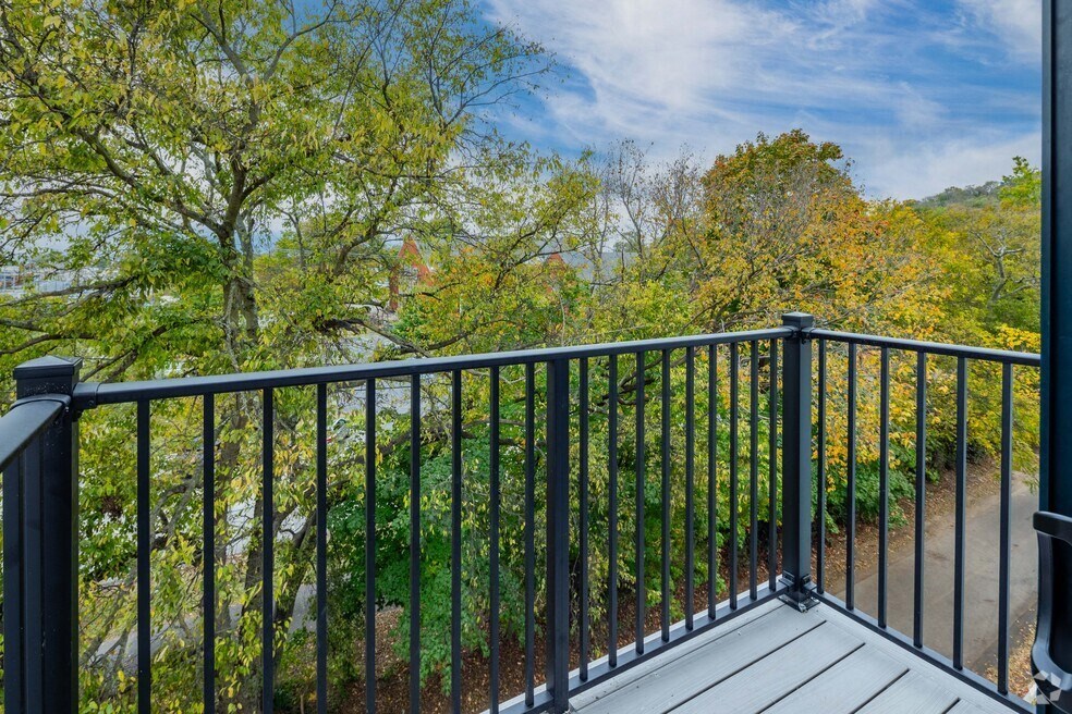 a balcony with a view of a garden and trees