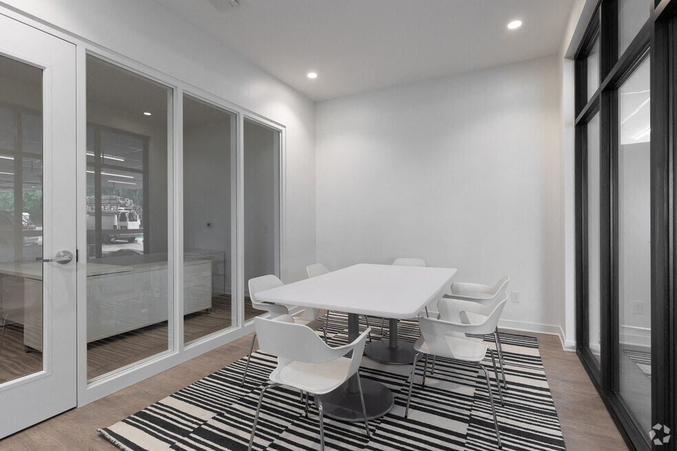 a dining room with a white table and chairs