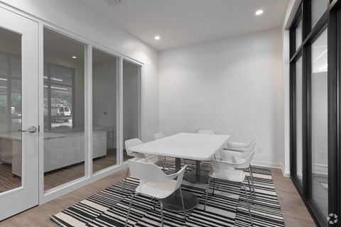a dining room with a white table and chairs