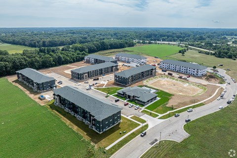 A large building complex with a parking lot in front.
