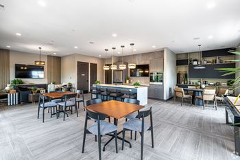 A modern dining room with a large table and chairs.