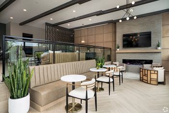 A modern living room with a fireplace and a television.