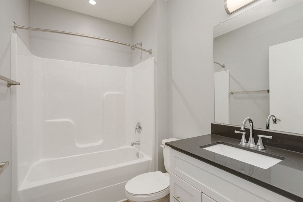 a bathroom with a sink toilet and a tub