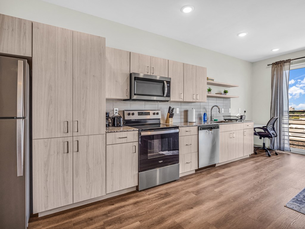 a kitchen with wooden cabinets and stainless steel appliances