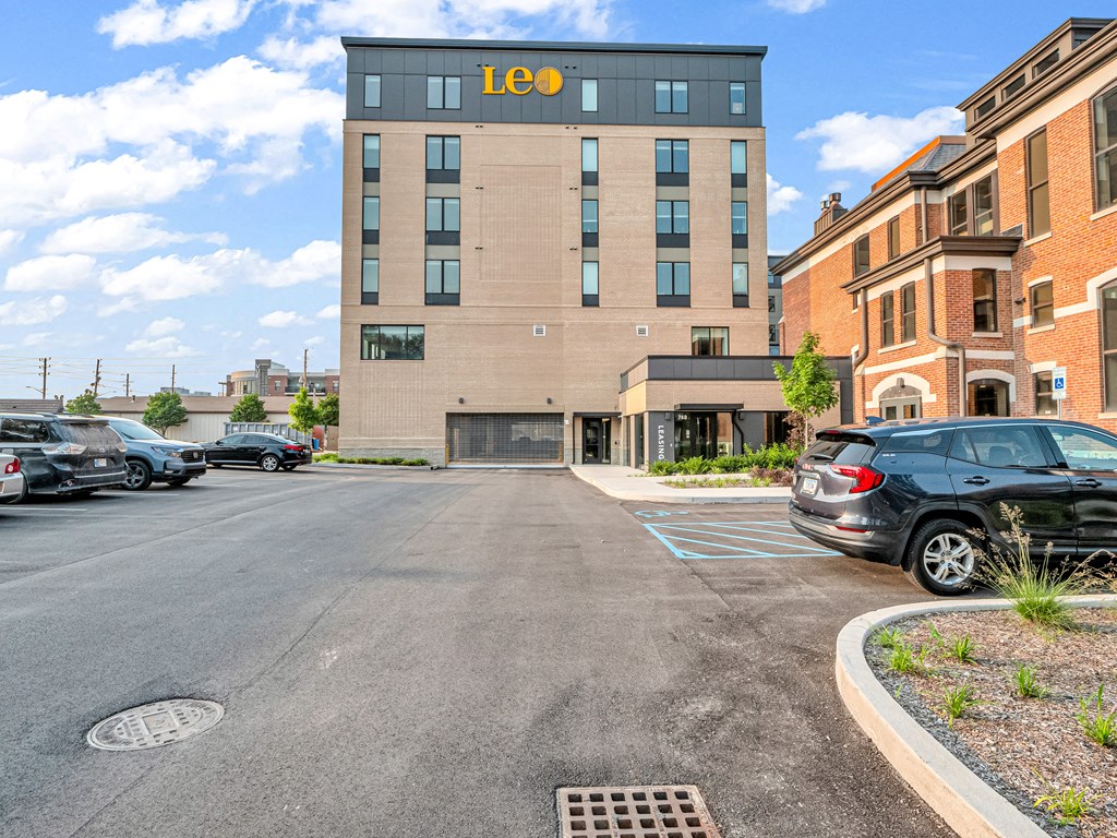 an exterior view of an apartment building with cars