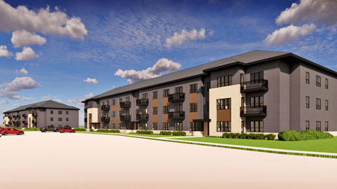 A modern apartment complex with a parking lot in front.