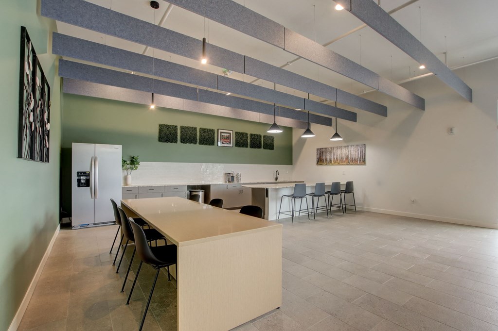 a kitchen and dining room with a long table and chairs