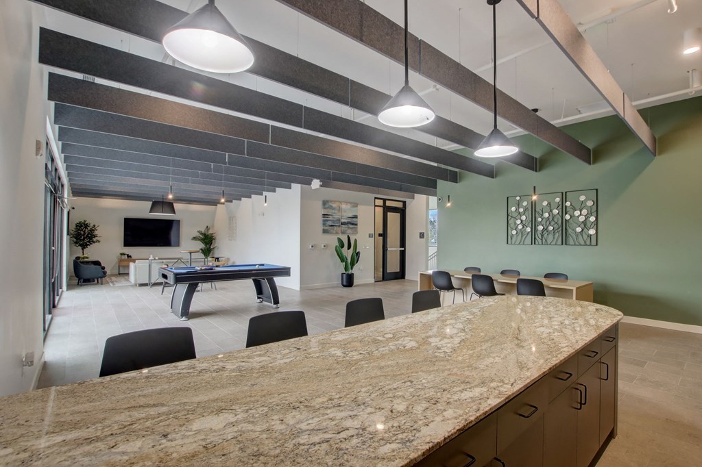 a clubhouse with a bar and a pool table