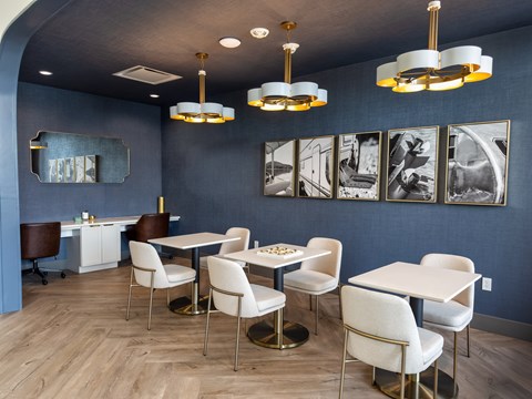 A dining room with white chairs and a table.