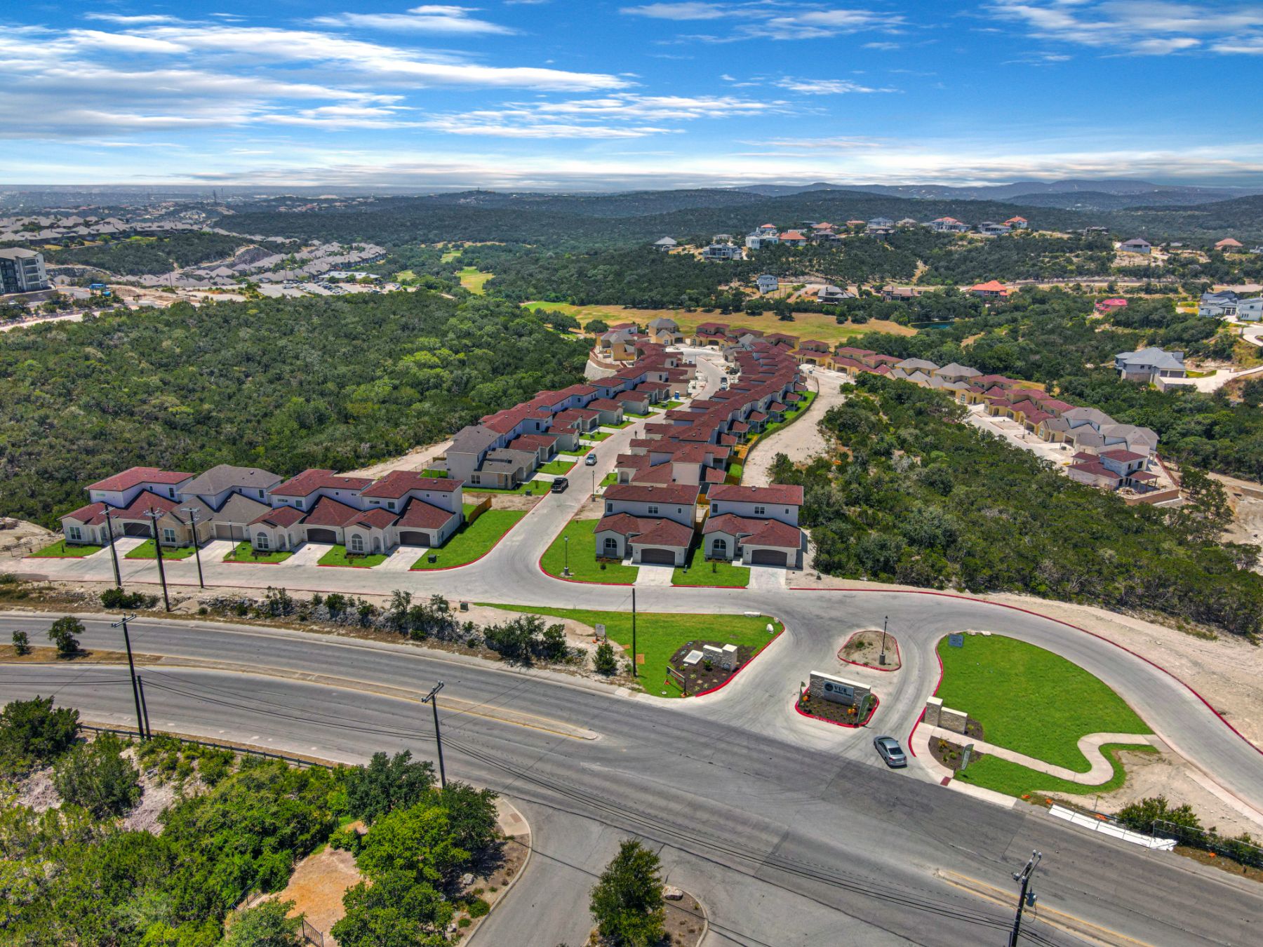 arial view of a subdivision with cars parked on the side of the road
